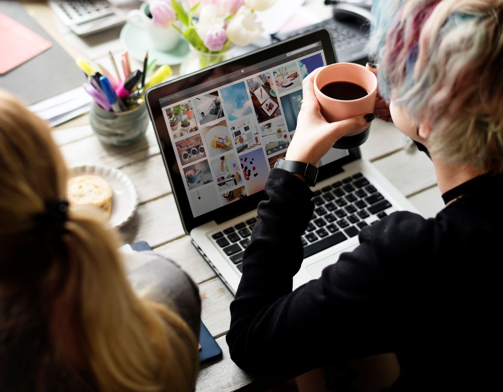 woman-hands-holding-coffee-cup-working-on-laptop-2025-02-10-05-49-13-utc.jpg